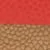 Gros plan d'une surface texturée avec une moitié supérieure rouge et lisse et une moitié inférieure marron et tissée.