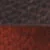 Gros plan d'une surface texturée avec une partie supérieure rugueuse, brun foncé, et une partie inférieure lisse, brun rougeâtre.