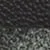 Gros plan d'une surface texturée avec un motif en nid d'abeille sur le dessus et une texture rugueuse et mouchetée en dessous.