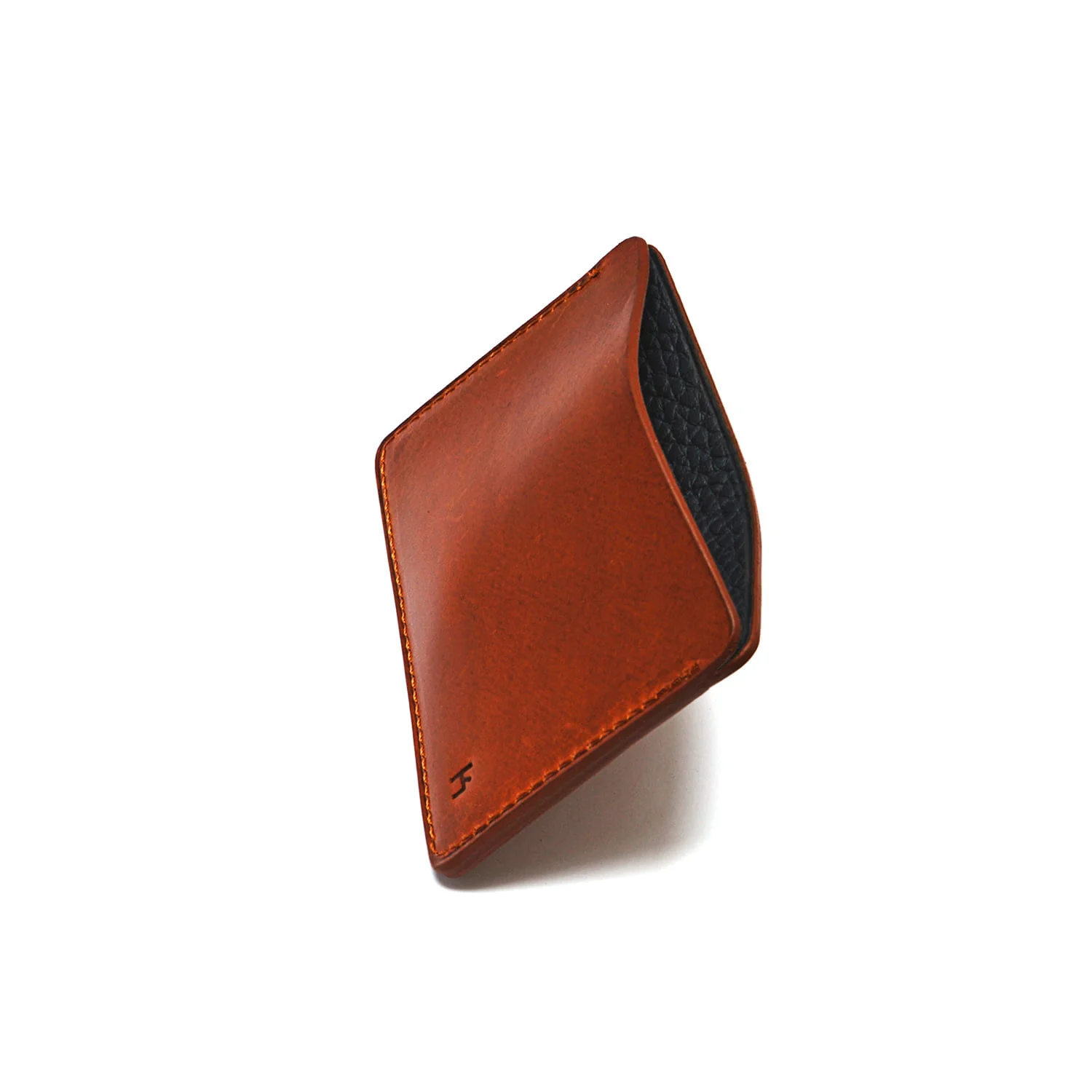Un portefeuille en cuir marron au design minimaliste, doté d'une poche visible et de coutures fines.