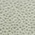 Gros plan d'une surface texturée avec un motif de petites bosses en relief, ressemblant à des écailles ou des points, de couleur vert clair.