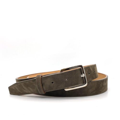 Une ceinture en cuir marron avec une boucle argentée, enroulée et posée sur un fond blanc.